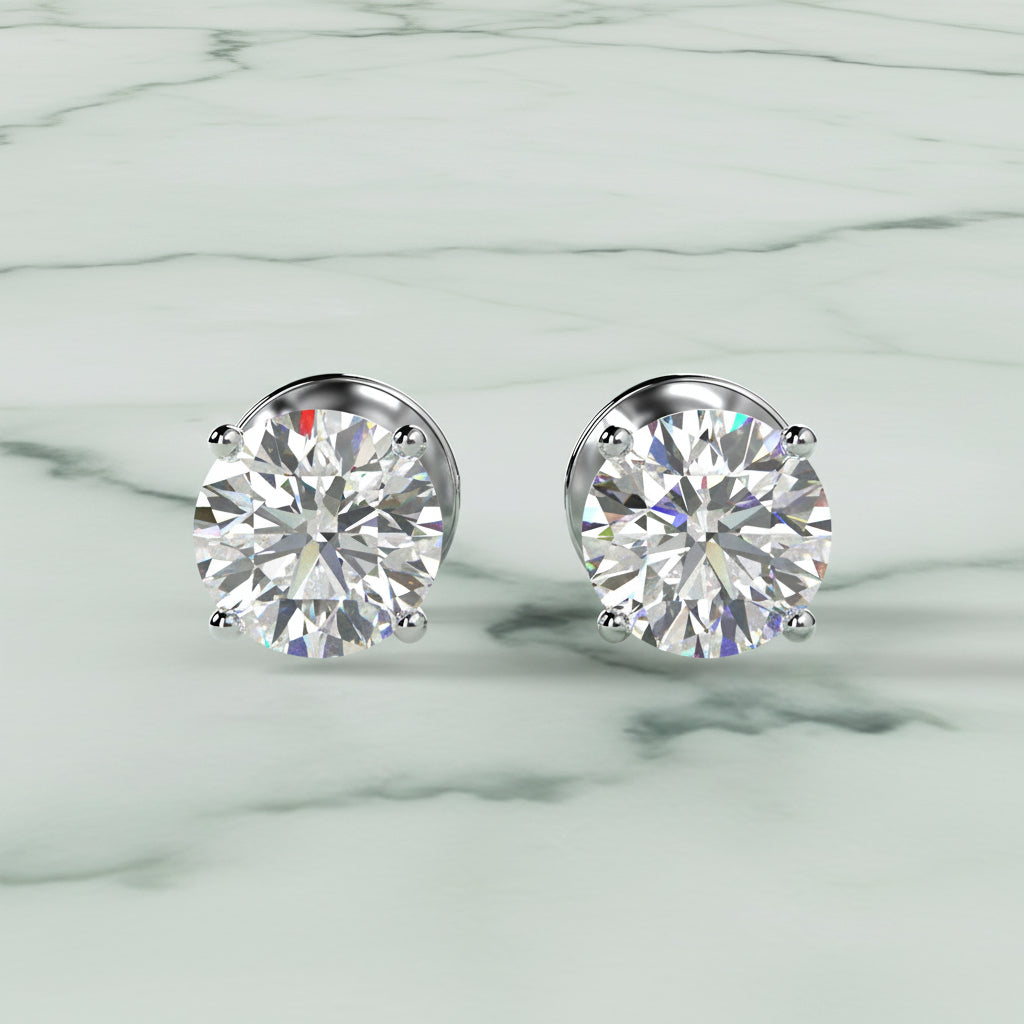 Pair of diamond stud earrings on a light beige background