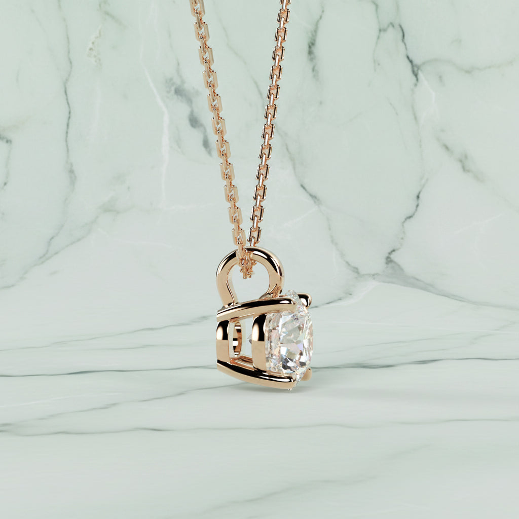 Rose gold necklace with a diamond pendant on a light beige background