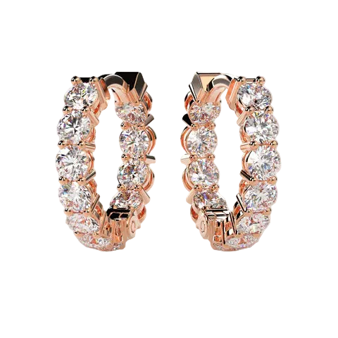 Rose gold hoop earrings with clear gemstones on a light beige background