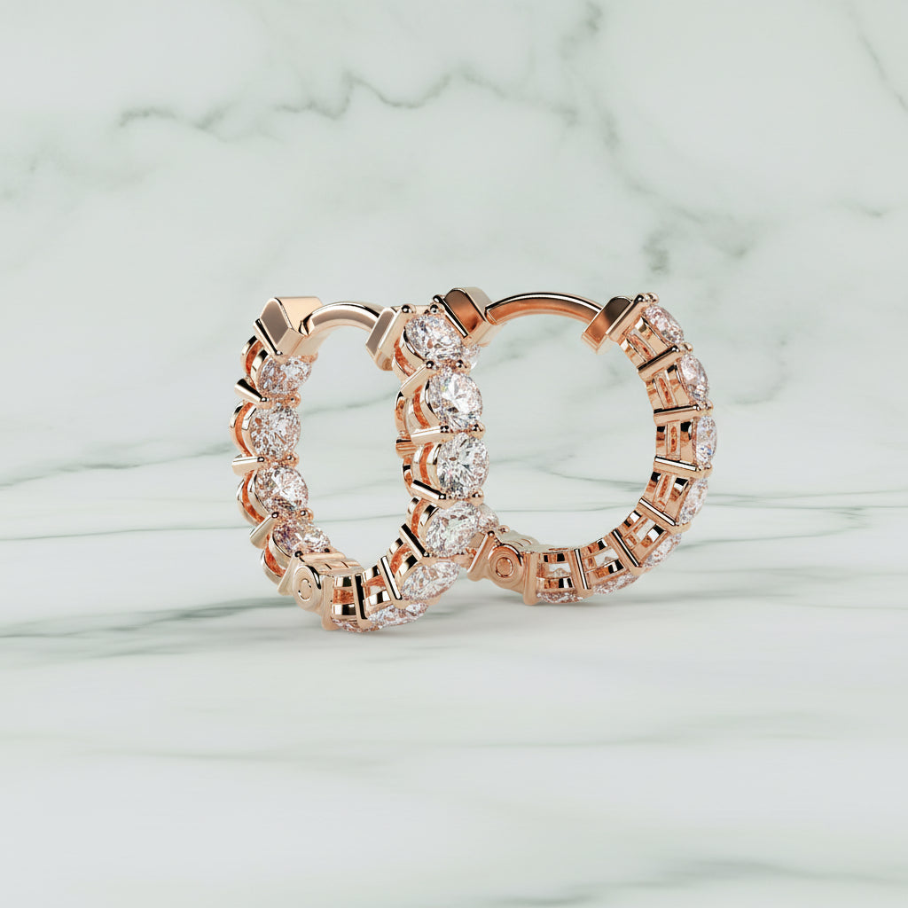 Rose gold hoop earrings with clear gemstones on a light beige background