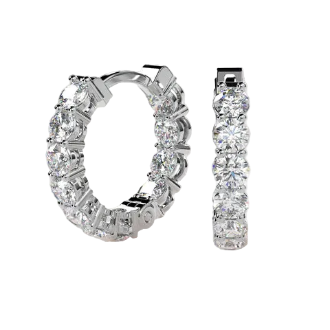 A pair of silver hoop earrings set with round-cut clear gemstones, shown from two angles against a light beige background. One earring is shown in profile, and the other is angled to show the back clasp.