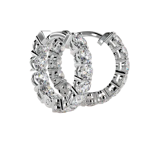 A pair of silver hoop earrings set with clear round-cut gemstones, displayed on a light beige background.