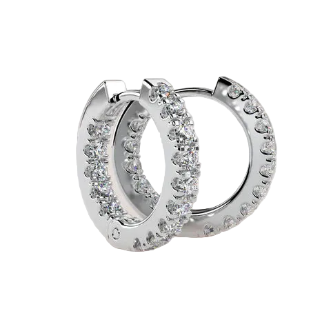 A pair of silver huggie hoop earrings embellished with clear pavé-set cubic zirconia stones, displayed on a soft beige background.