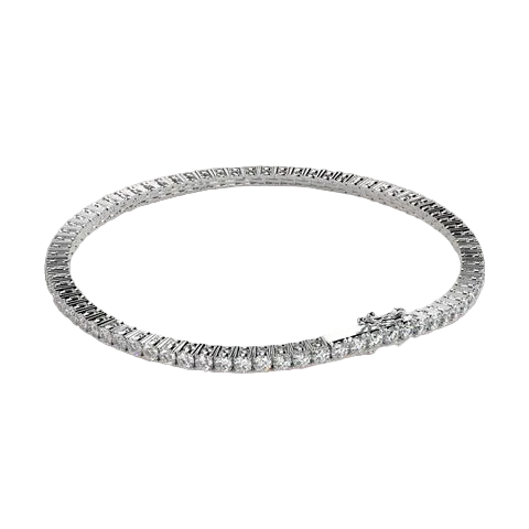A silver-toned tennis bracelet with a small floral accent at the clasp, displayed on a solid light beige background.