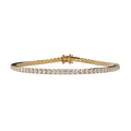 A yellow gold tennis bracelet with a continuous row of round-cut clear gemstones, displayed on a light beige background.