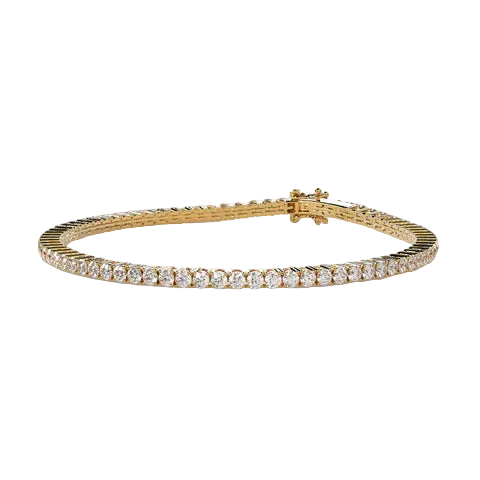 A yellow gold tennis bracelet featuring a row of round-cut clear gemstones, displayed on a neutral light beige background.