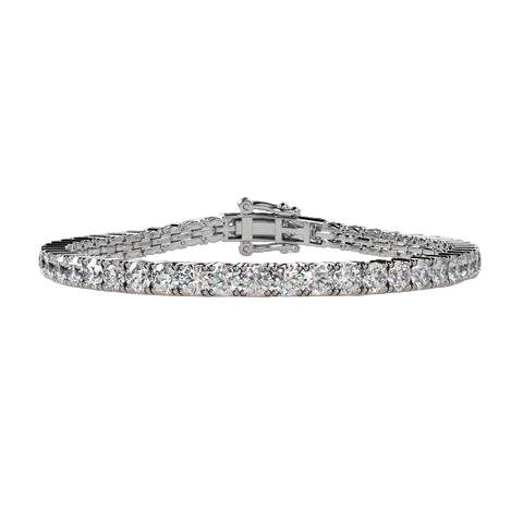 A silver tennis bracelet with a continuous row of clear round-cut stones, displayed on a light beige background.