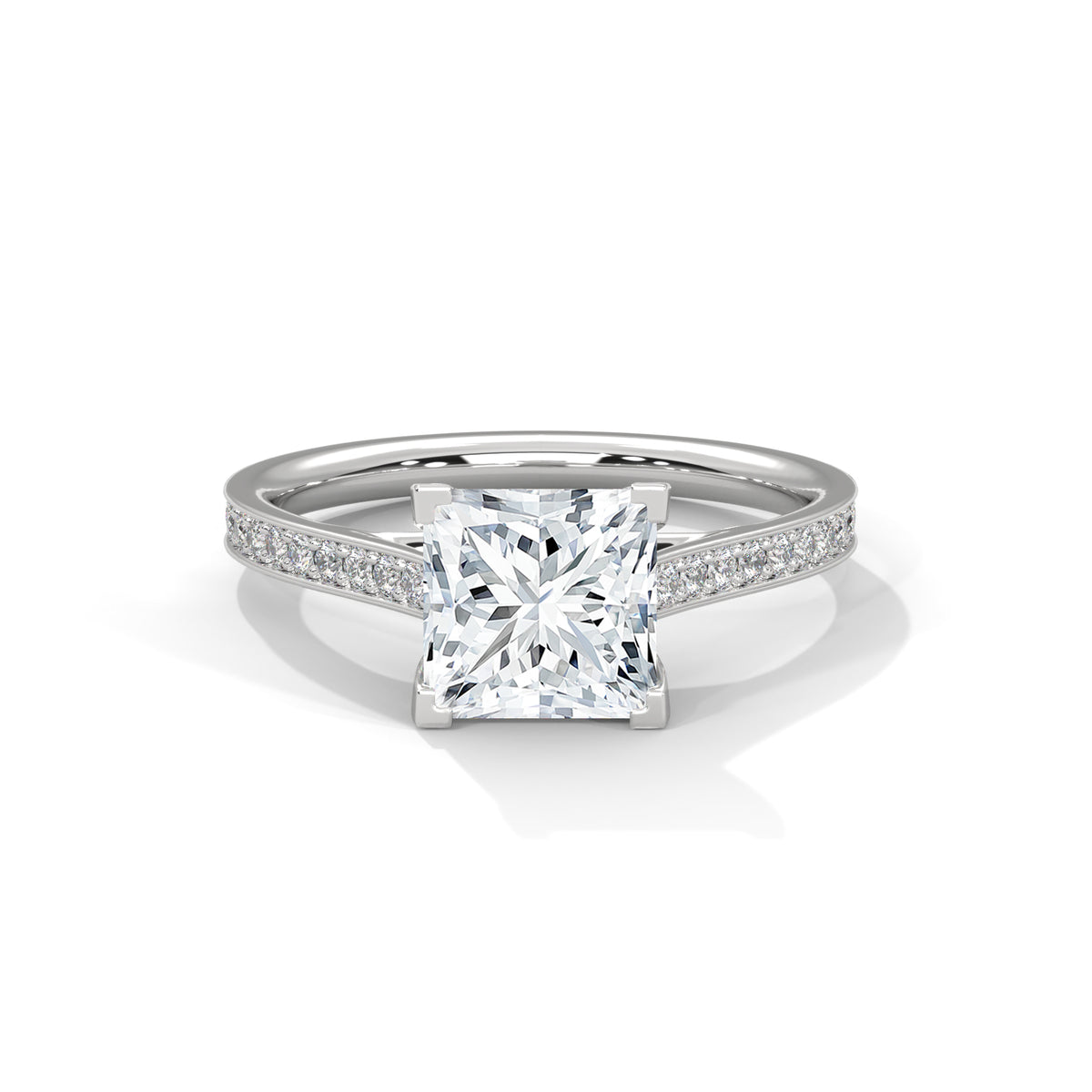 Silver ring with a large diamond and smaller diamonds on the band against a white background