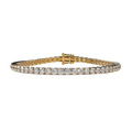 Gold bracelet with diamonds on a beige background