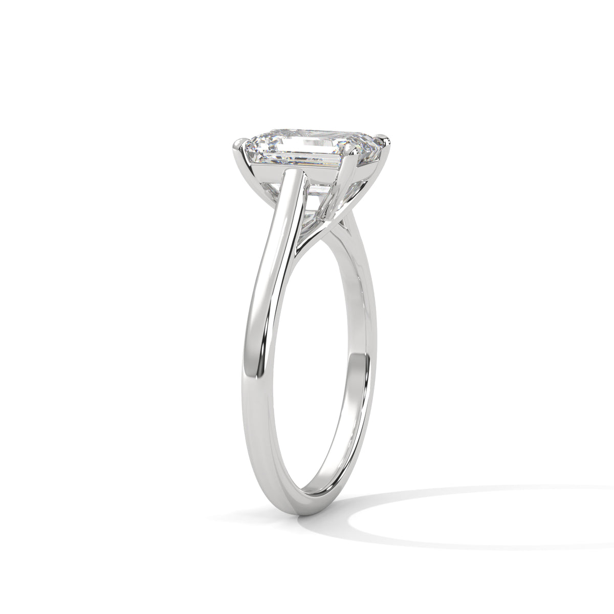 A silver-tone solitaire engagement ring featuring a large cushion-cut diamond, shown in a three-quarter side view on a clean white background with a soft shadow.