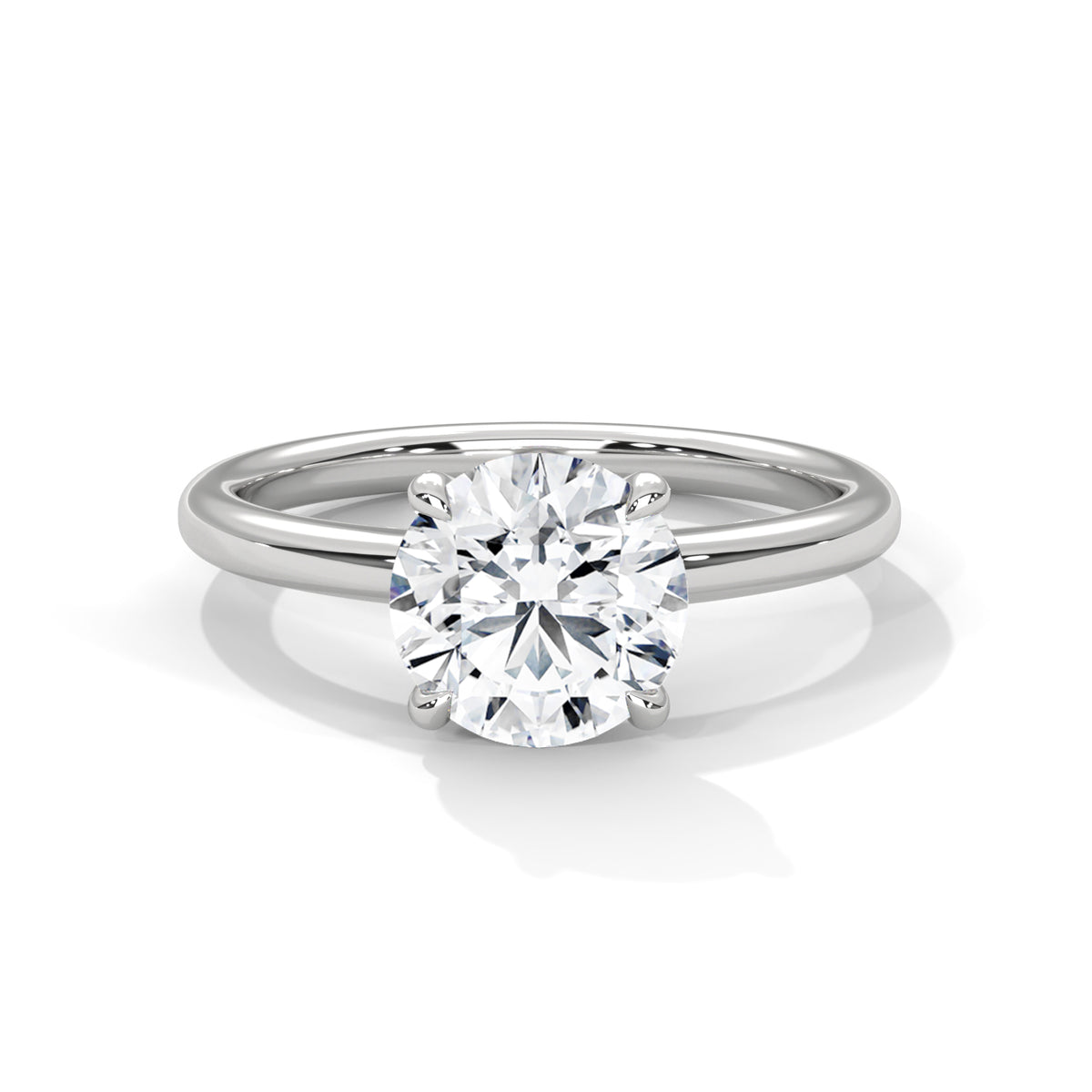 Diamond ring with emerald-cut center stone on a white background