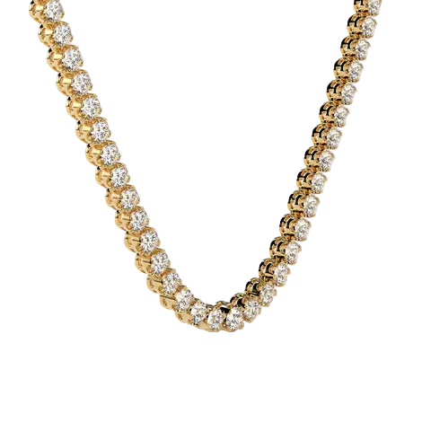 A close-up of a gold tennis necklace with round-cut clear stones, arranged in a U-shape against a soft beige background.