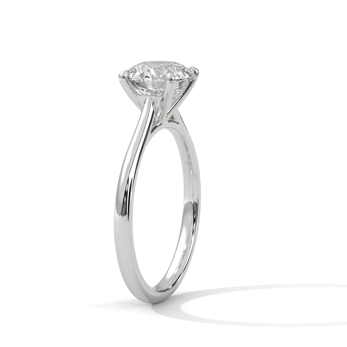 A classic solitaire diamond engagement ring in a polished four-prong setting, shown from a side profile view on a clean white background with a soft shadow.