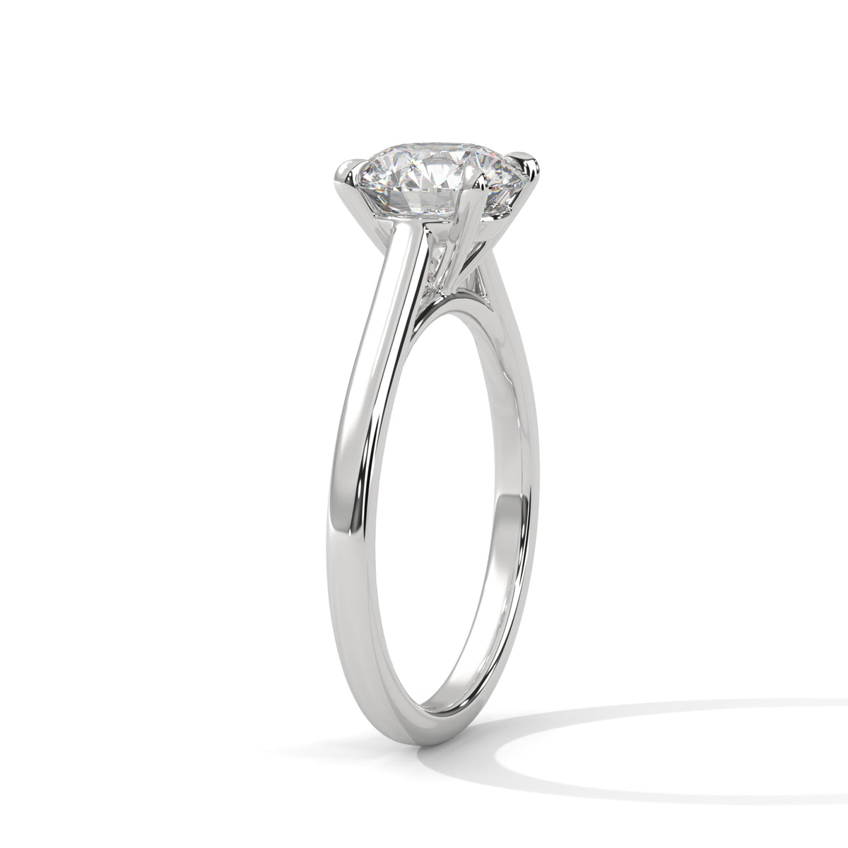 A classic solitaire engagement ring featuring a round brilliant-cut diamond set in a polished white gold or platinum band, shown from a side profile view on a clean white background.