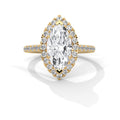 Gold ring with a large diamond and smaller diamonds on the band against a white background