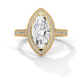 A yellow gold marquise-cut diamond ring with a halo of smaller diamonds and a pavé band, shown on a clean white background with a soft shadow.
