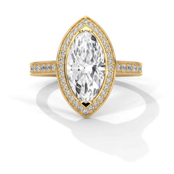 A yellow gold marquise-cut diamond ring with a halo of smaller diamonds and a pavé band, shown on a clean white background with a soft shadow.