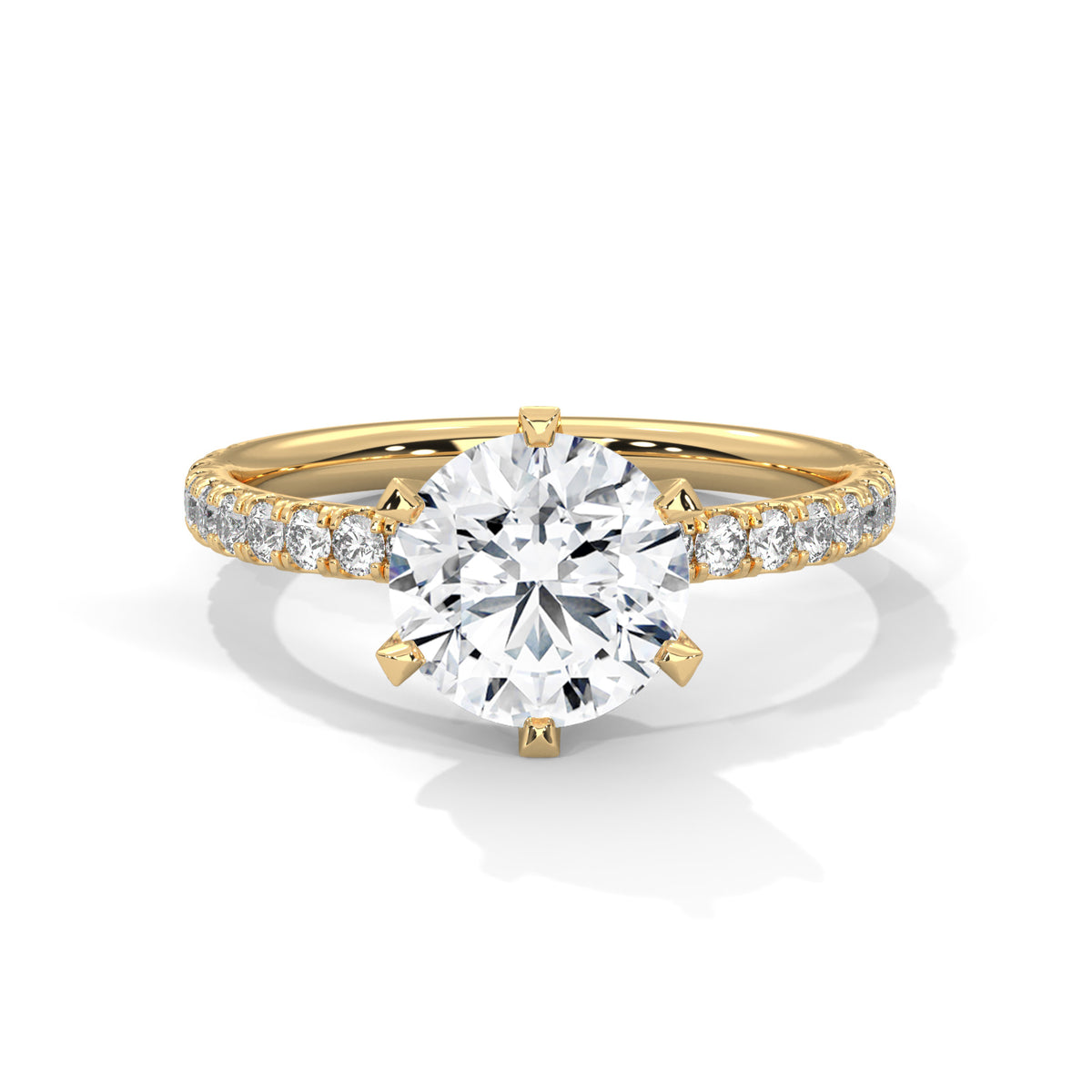 Gold ring with a large diamond and smaller diamonds on the band against a white background