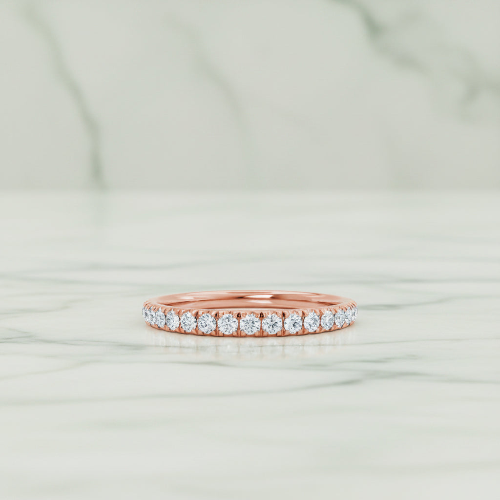 Rose gold ring with diamonds on a white background