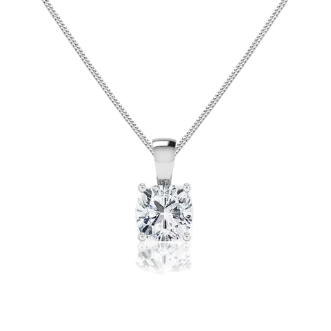 A classic solitaire diamond pendant necklace on a delicate silver chain, set against a clean white background with a soft reflection below.