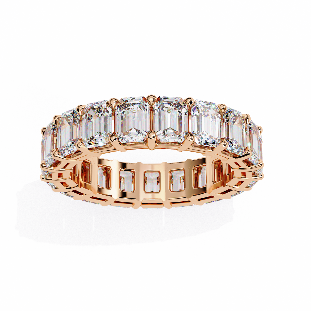 Rose gold ring with emerald-cut diamonds on a white background
