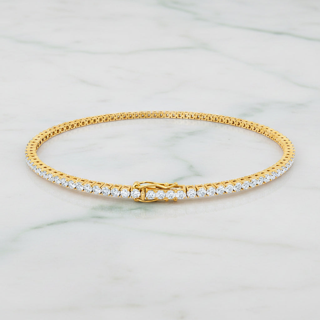 Gold bracelet with diamonds on a white background