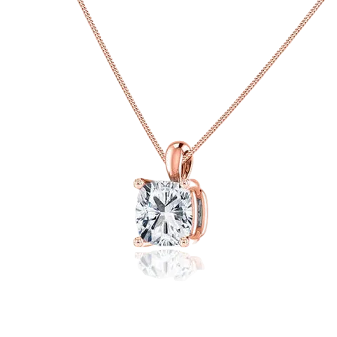 A square cushion-cut diamond pendant necklace in a rose gold setting on a delicate rose gold chain, shown against a white background with a soft reflection below.