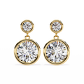 Gold earrings with large clear gemstones on a white background