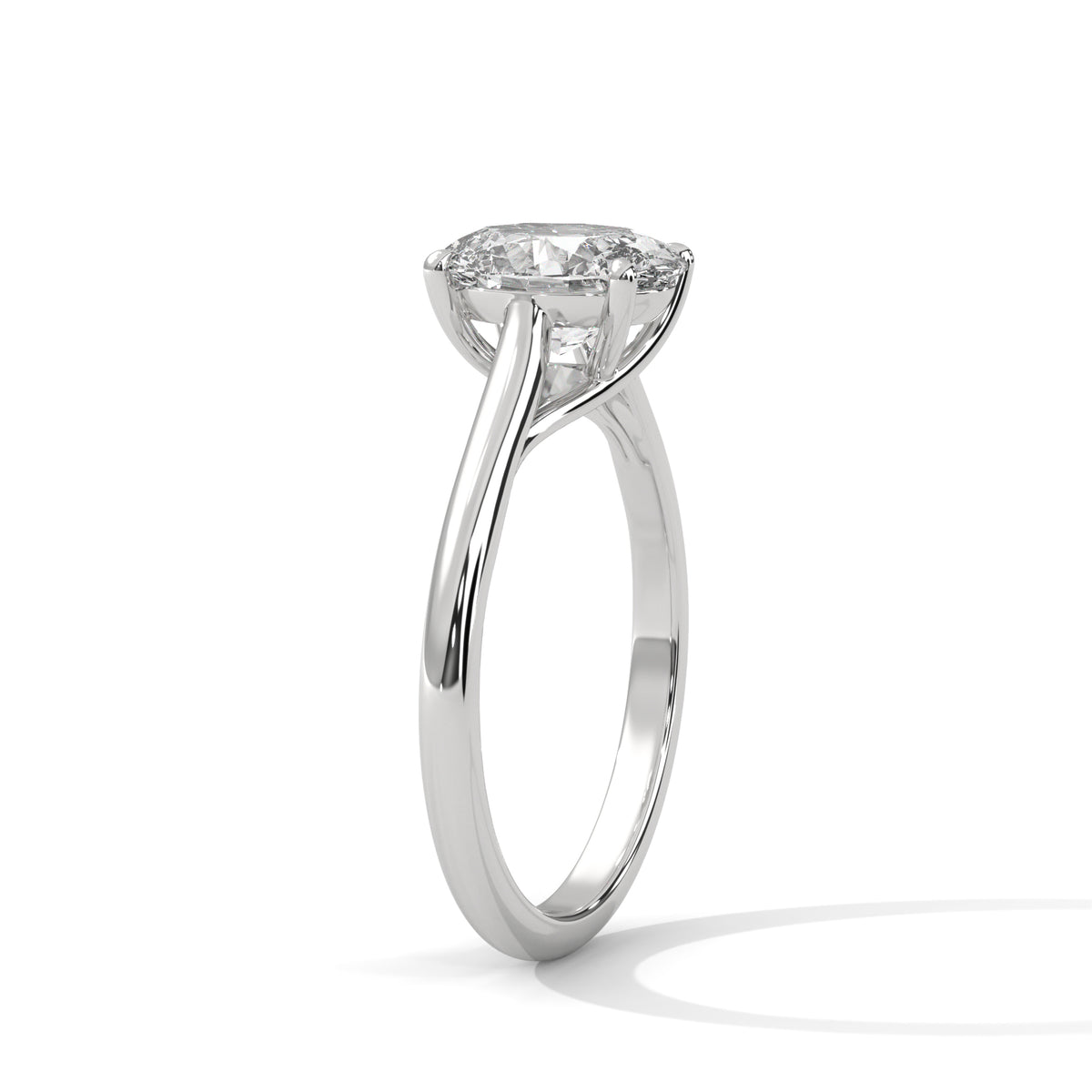 A silver-tone solitaire engagement ring with a round brilliant-cut diamond, shown in a three-quarter side view on a clean white background.