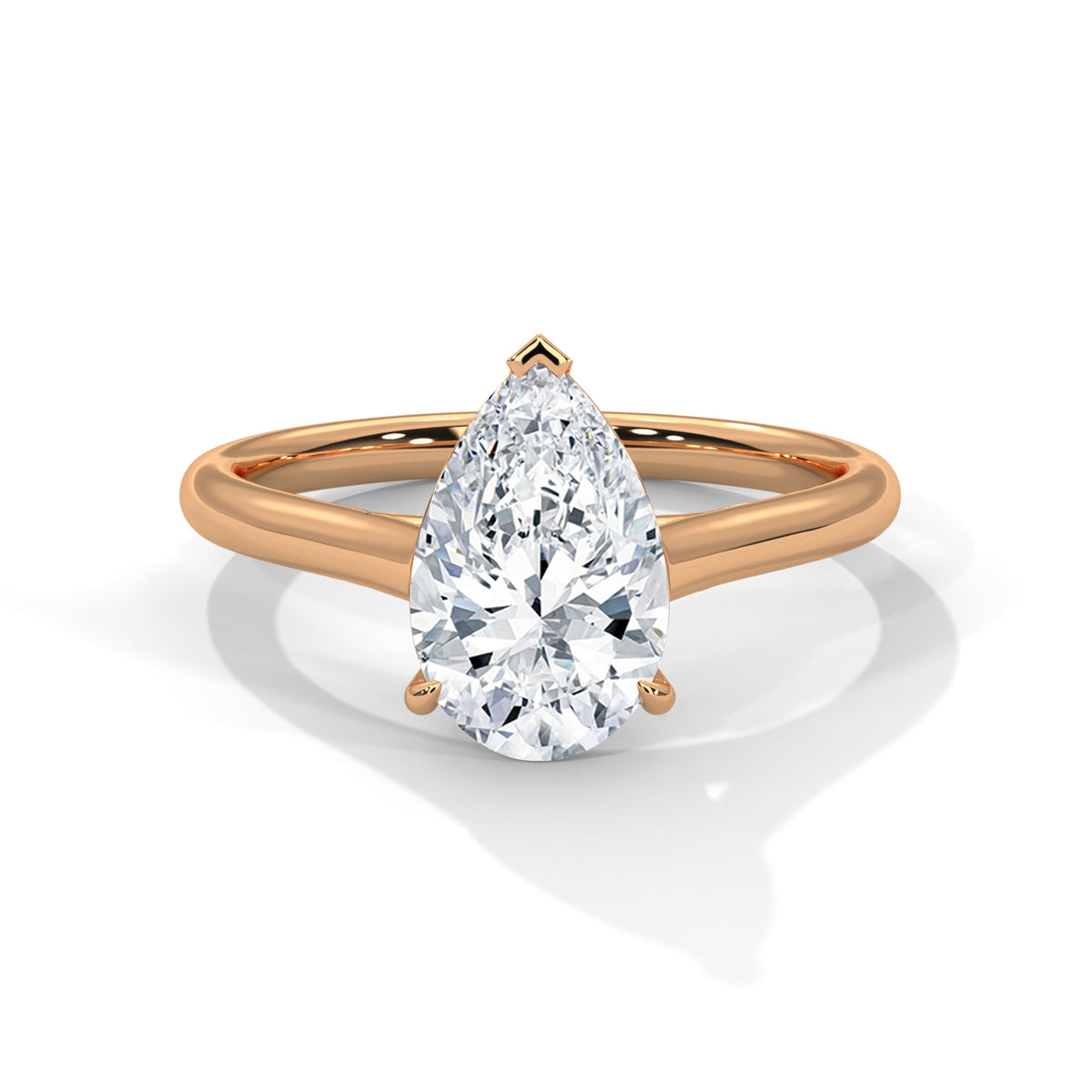 Rose gold ring with a pear-shaped diamond on a white background