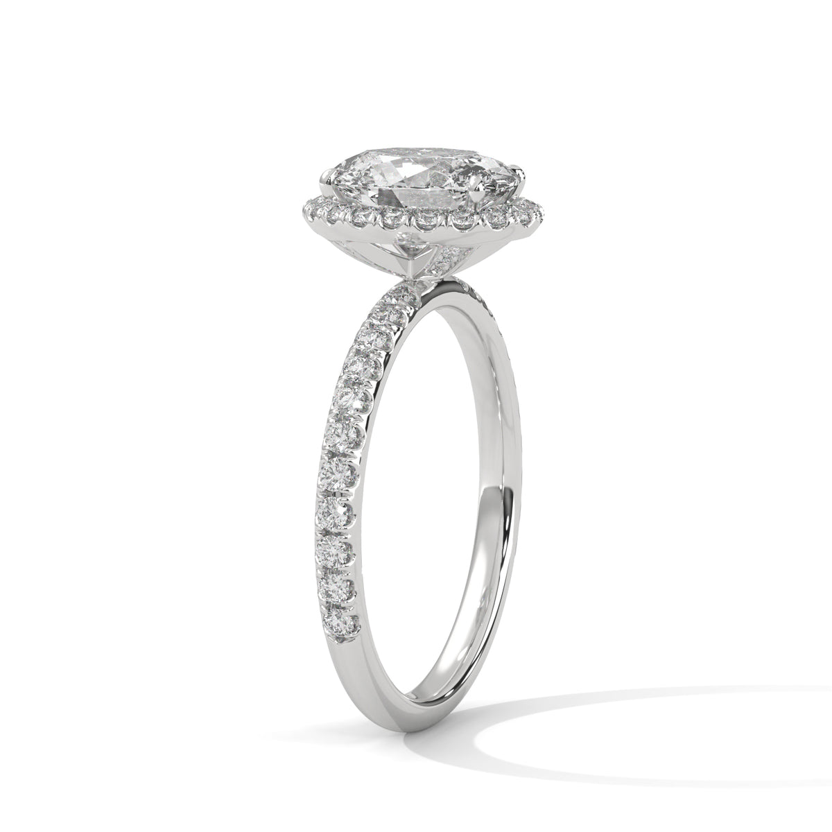 Diamond ring with a halo setting on a white background