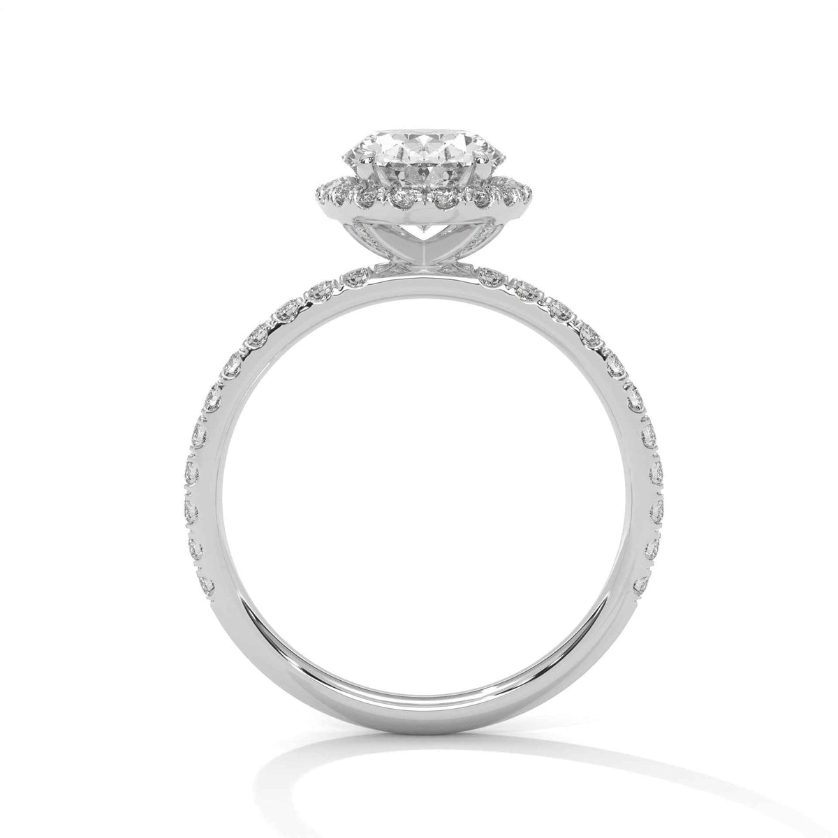 A silver-toned diamond engagement ring with a round-cut center stone and a halo of smaller diamonds, set against a clean white background.