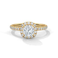 Gold ring with a large diamond and smaller diamonds on the band against a white background