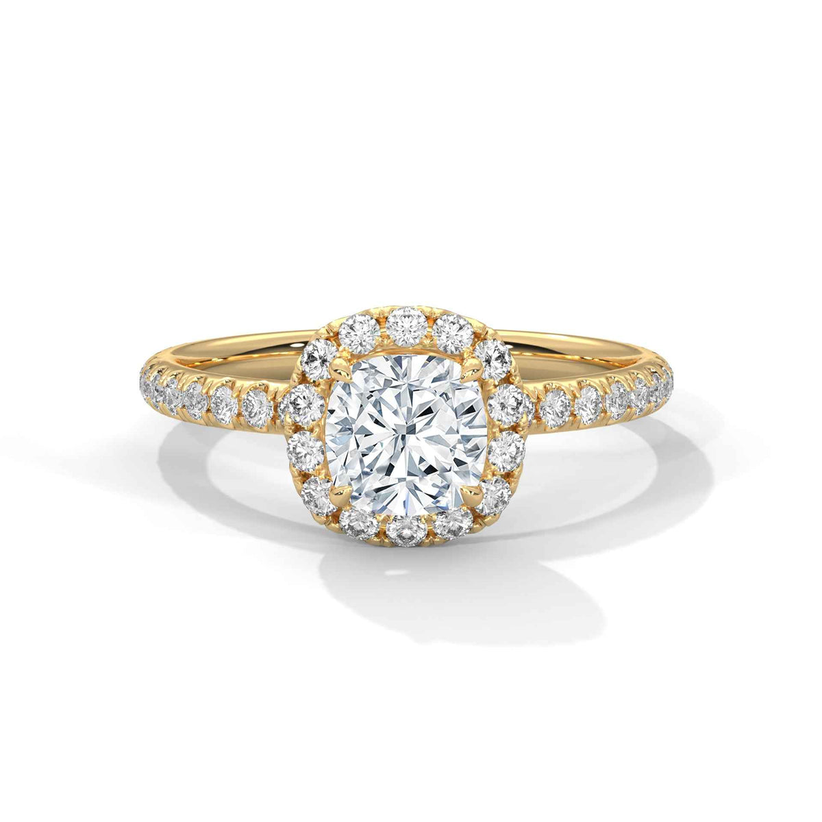 Gold ring with a large diamond and smaller diamonds on the band against a white background