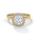 A yellow gold ring with a large round brilliant-cut center diamond surrounded by a halo of smaller diamonds, set on a polished gold band against a clean white background.