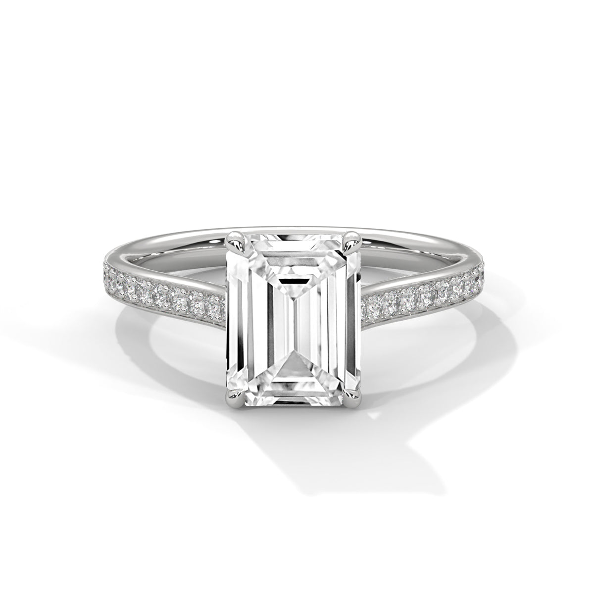 Diamond ring with emerald-cut center stone on a white background