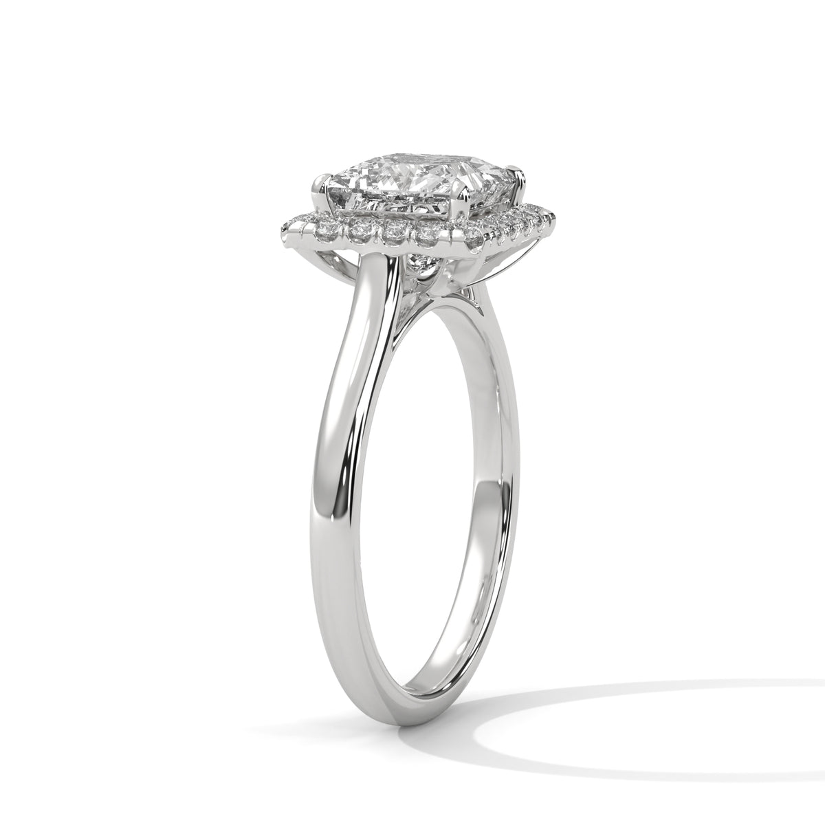 Silver ring with a diamond halo on a white background