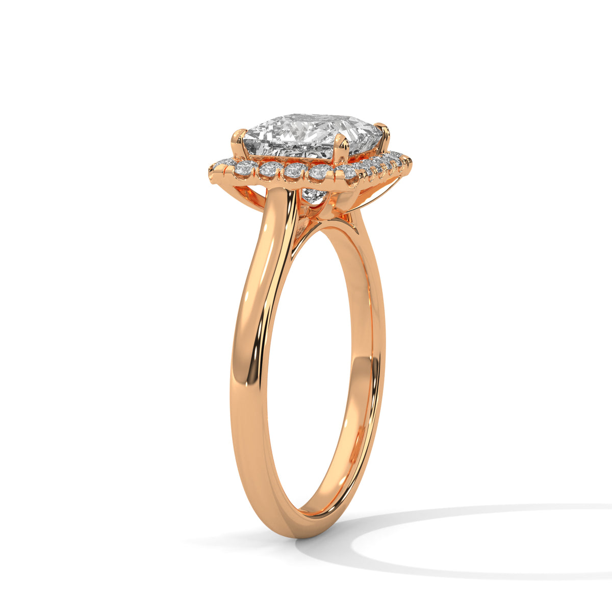 Rose gold ring with a diamond halo on a white background