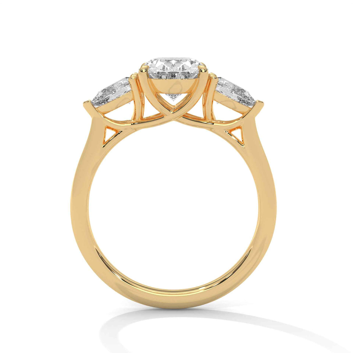 A yellow gold three-stone diamond ring with a central oval-cut diamond and two marquise-cut diamonds on either side, set against a clean white background.