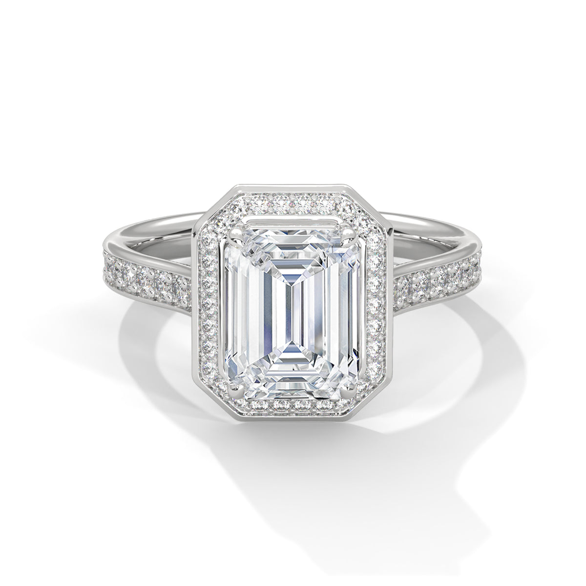 Diamond ring with emerald-cut center stone on a white background