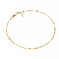 Gold bracelet with small diamond-like stones on a white background