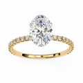 Gold ring with a large diamond and smaller diamonds on the band against a white background