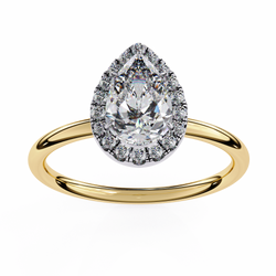 Gold ring with a pear-shaped diamond and halo on a white background