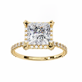 Gold ring with a large diamond and smaller diamonds on the band against a white background