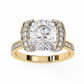 Gold ring with a large diamond and smaller diamonds on the band against a white background