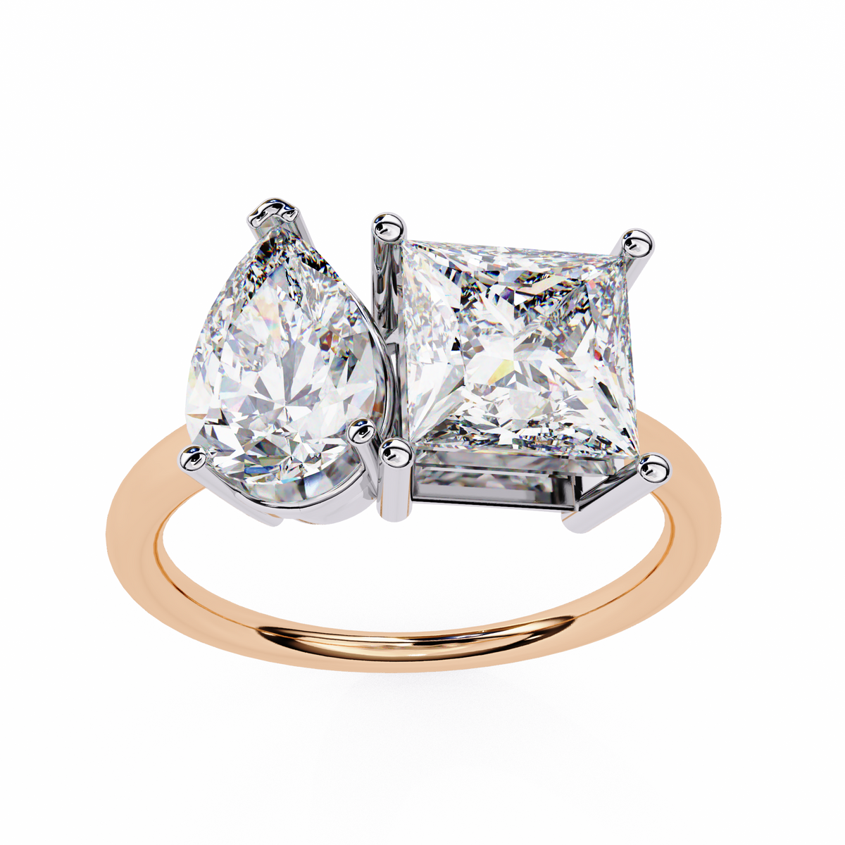 Diamond ring with pear-shaped and princess-cut diamonds on a white background