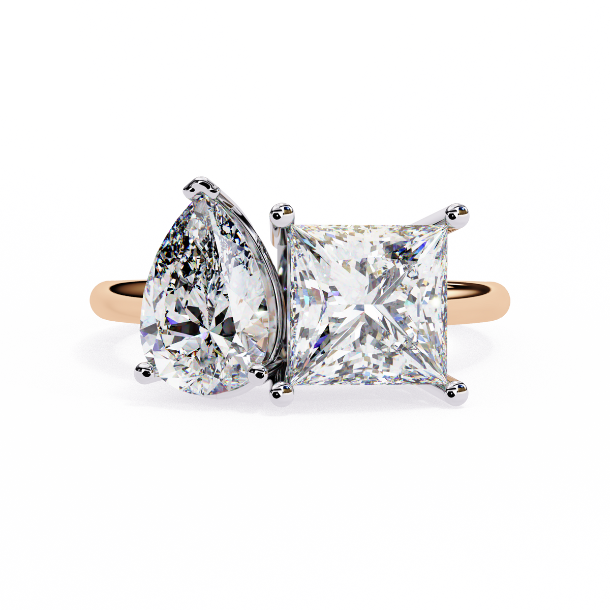 Diamond ring with pear-shaped and princess-cut diamonds on a white background
