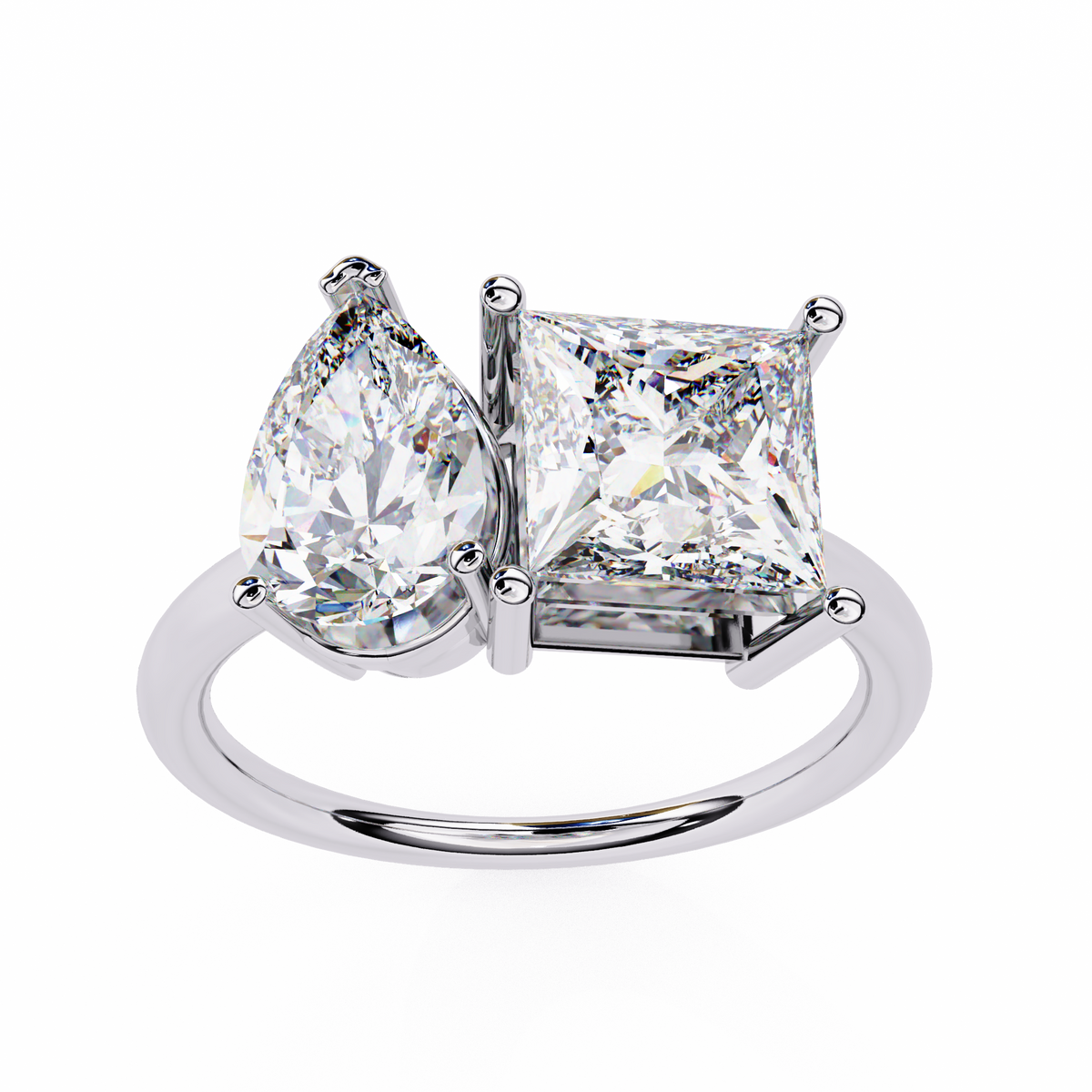 Diamond ring with pear-shaped and princess-cut diamonds on a white background