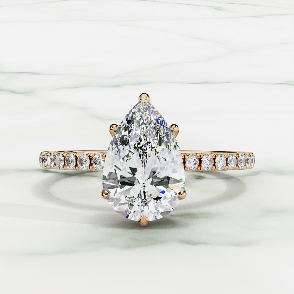 Diamond ring with a pear-shaped center stone on a white background