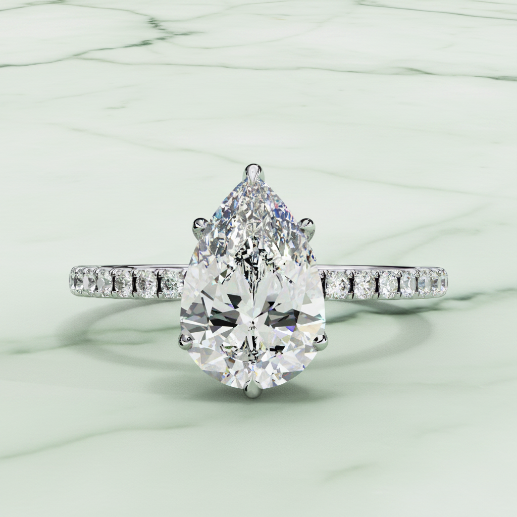 Diamond ring with a pear-shaped center stone on a white background
